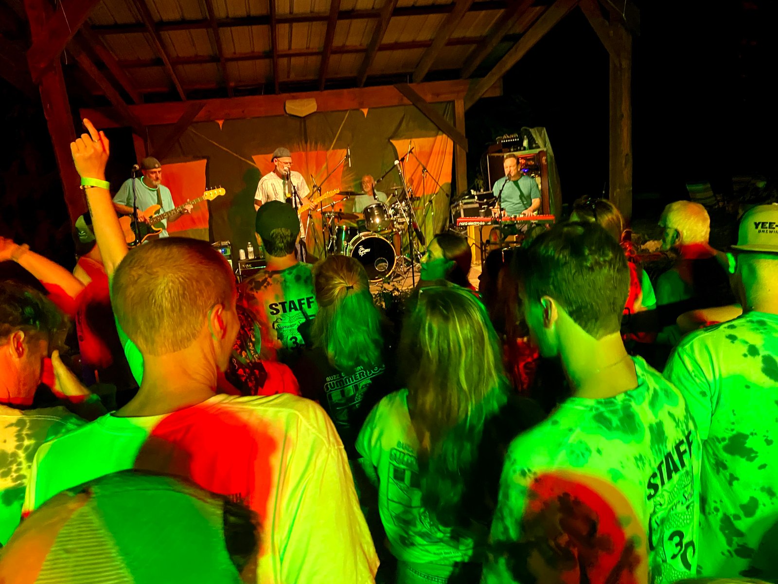 A nighttime crowd watching the band perform at Brandywine Outfitters
